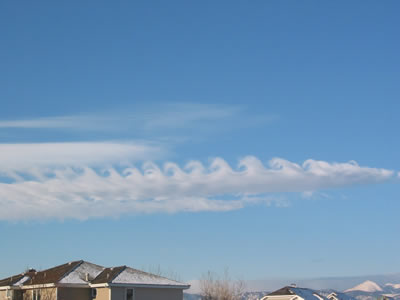 <a href="/earth/Atmosphere/clouds/kelvin_helmholtz.html&edu=high&dev=1/windows.html">Kelvin-Helmholtz</a>
  clouds resemble breaking <a
  href="/earth/Water/ocean_waves.html&edu=high&dev=1/windows.html">waves in
  the ocean</a>. They are usually the most developed near mountains or large
  hills. Wind deflected up and over a barrier, like a mountain, continues
  flowing through the air in a wavelike pattern. Complex <a
  href="/earth/Water/evaporation.html&edu=high&dev=1/windows.html">evaporation</a>
  and <a href="/earth/Water/condensation.html&edu=high&dev=1/windows.html">condensation</a>
  patterns create the capped tops and cloudless troughs of the waves. This
  image was taken on February 9, 2003 in the morning in Boulder, Colorado.<p><small><em>       Courtesy of Roberta Johnson</em></small></p>