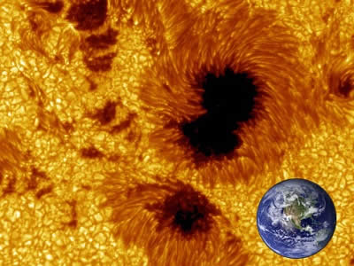 Sunspots don't look that big when you see them on the Sun (remember NEVER look directly at the Sun), but in fact they can be enormous!  This composite image shows just how big sunspots can be, to scale with an image of Earth.  Sunspots can be as big, or bigger, than Earth.  The <a href="/sun/activity/sunspot_history.html&edu=high&dev=">earliest written record of a sunspot observation</a> was made by Chinese astronomers around 800 B.C.<p><small><em>Image courtesy of Windows to the Universe using images from the Royal Swedish Academy of Sciences (sunspot image) and NASA (Earth image).</em></small></p>